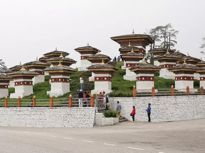 The 108 chortens on the Dochu La pass, with cloud in the trees behind