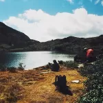 Jimilang Tsho, a lake high on the Druk Path, with walkers resting on its shore