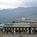 Mongar town on its hillside, with traditional shop-houses in the foreground