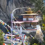Tiger's Nest monastery on its cliff, seen through strings of prayer flags
