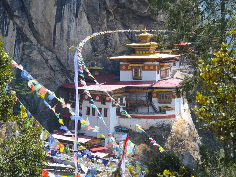 Tiger's Nest monastery on its cliff, seen through strings of prayer flags