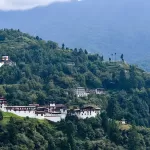 Trongsa Dzong strung along its ridge on a forested hillside above the Mangde Chhu