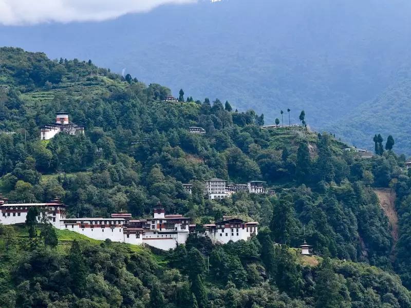 Trongsa Dzong strung along its ridge on a forested hillside above the Mangde Chhu