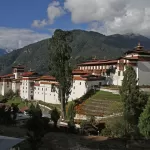 The white walls and red roofs of Trongsa Dzong on its ridge