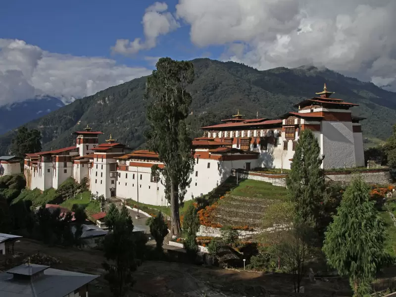 The white walls and red roofs of Trongsa Dzong on its ridge