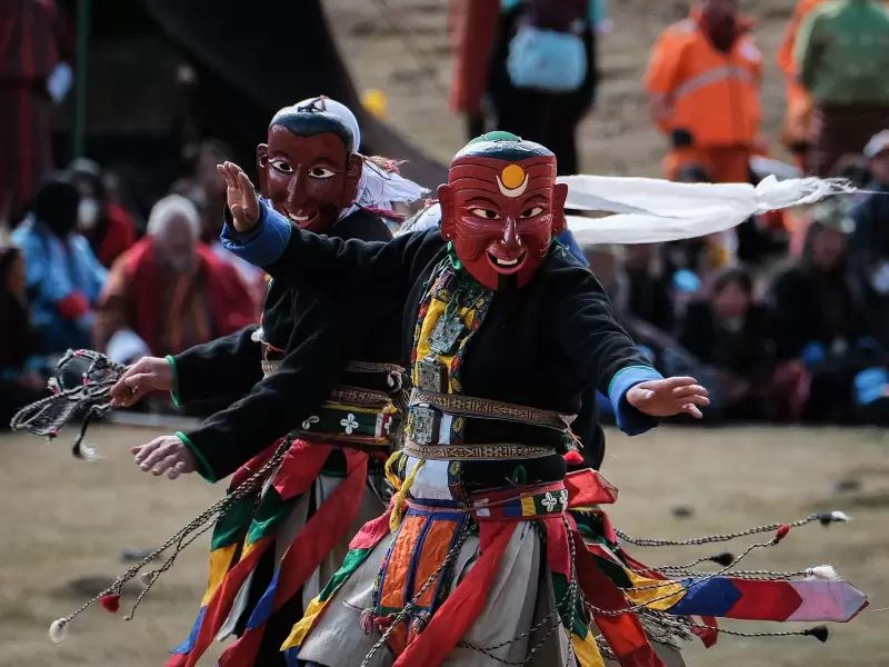 A masked dancer in mid-turn at a tshechu in Bhutan