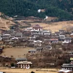 The closely packed houses of Ura village in Bumthang, with its temple above them